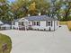 Charming house with updated siding, shutters, large concrete driveway, and professional landscaping at 253 Mcintosh Avenue Ne, Marietta, GA 30060
