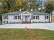 Charming renovated ranch with blue front door, new landscaping and a large driveway at 253 Mcintosh Avenue Ne, Marietta, GA 30060