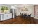 Bright kitchen featuring stainless steel appliances, granite countertops, and hardwood floors extending to the dining area at 253 Mcintosh Avenue Ne, Marietta, GA 30060