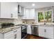 Modern kitchen with white cabinets, stainless steel appliances and granite countertops at 253 Mcintosh Avenue Ne, Marietta, GA 30060