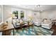 Bright living room featuring hardwood floors, a stylish rug, and lots of seating at 253 Mcintosh Avenue Ne, Marietta, GA 30060