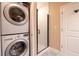 Bathroom with a subway-tiled walk-in shower and stacked washer and dryer at 923 Peachtree Ne St # 932, Atlanta, GA 30309