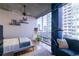 Bright bedroom with floor-to-ceiling windows, hardwood floors, and stylish furnishings at 923 Peachtree Ne St # 932, Atlanta, GA 30309