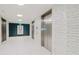 Elevator bay with stainless steel elevators and tile floors at 923 Peachtree Ne St # 932, Atlanta, GA 30309