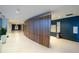 Hallway features tile floor, wood accent wall and blue painted wall at 923 Peachtree Ne St # 932, Atlanta, GA 30309