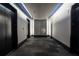 Hallway leading to elevators with a modern design and recessed lighting at 923 Peachtree Ne St # 932, Atlanta, GA 30309