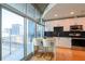 Modern kitchen with white cabinets, stainless steel appliances, and a breakfast bar overlooking the city at 923 Peachtree Ne St # 932, Atlanta, GA 30309