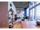 Open concept living room with city views and a view into the bedroom at 923 Peachtree Ne St # 932, Atlanta, GA 30309