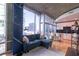 Cozy living room area with a comfortable blue couch, city views and a modern kitchen at 923 Peachtree Ne St # 932, Atlanta, GA 30309