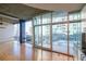 A living room featuring floor-to-ceiling windows with a balcony overlooking a pool at 923 Peachtree Ne St # 932, Atlanta, GA 30309