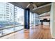 Bright living room with floor-to-ceiling windows and a view of the city and the kitchen at 923 Peachtree Ne St # 932, Atlanta, GA 30309