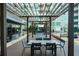 Charming condominium patio area with shaded seating and lush green landscaping at 923 Peachtree Ne St # 932, Atlanta, GA 30309