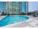 Community outdoor swimming pool with ladder and plenty of deck space for residents at 923 Peachtree Ne St # 932, Atlanta, GA 30309