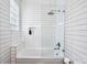 Modern bathroom featuring a shower-over-tub with white tiles and a sleek glass screen at 996 Blue Ridge Ne Ave, Atlanta, GA 30306
