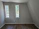 Bedroom with hardwood floors and natural light from the two windows at 1920 Moores Mill Nw Rd, Atlanta, GA 30318