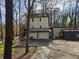 Unique two-story home with a two-car garage, deck, and driveway at 1920 Moores Mill Nw Rd, Atlanta, GA 30318