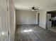 Open-concept living area with new flooring, a ceiling fan, and access to kitchen at 1920 Moores Mill Nw Rd, Atlanta, GA 30318