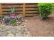 Landscaped backyard features a stone patio, lush greenery, and a wooden fence creating a peaceful retreat at 2021 Towneship Trl, Roswell, GA 30075