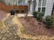 Backyard featuring stone pathway, bushes, and a small concrete patio at 2021 Towneship Trl, Roswell, GA 30075