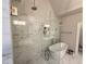 A bright bathroom featuring marble tile, a glass shower enclosure, and a rain shower head at 2021 Towneship Trl, Roswell, GA 30075