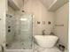 Bright bathroom showcases a walk-in shower, soaking tub, and modern fixtures at 2021 Towneship Trl, Roswell, GA 30075