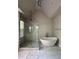 Modern bathroom features a glass shower and a soaking tub at 2021 Towneship Trl, Roswell, GA 30075