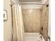 Clean white shower and bathtub, surrounded by neutral-toned tiling at 2021 Towneship Trl, Roswell, GA 30075