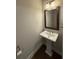 Bathroom featuring a pedestal sink, framed mirror, and modern fixtures for a clean, updated look at 2021 Towneship Trl, Roswell, GA 30075