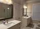 This bright bathroom features marble flooring, double mirrors, and a glass shower enclosure at 2021 Towneship Trl, Roswell, GA 30075
