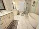 A bright bathroom featuring a glass shower, tub, and double vanity at 2021 Towneship Trl, Roswell, GA 30075