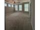 Carpeted main bedroom with ceiling fan and multiple windows at 2021 Towneship Trl, Roswell, GA 30075