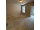 Neutral bedroom with carpet flooring, window, and a doorway to a walk-in closet at 2021 Towneship Trl, Roswell, GA 30075