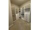 Walk-in closet has custom shelving and drawers for organized storage at 2021 Towneship Trl, Roswell, GA 30075
