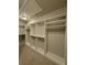 Walk-in closet with multiple shelves and rods at 2021 Towneship Trl, Roswell, GA 30075