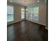 Dining area featuring large windows, dark wood floors, and a chandelier at 2021 Towneship Trl, Roswell, GA 30075