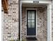 Charming front door with black door and brick facade for added curb appeal at 2021 Towneship Trl, Roswell, GA 30075
