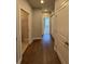 A hallway with hardwood floors offers inviting access to various rooms and features stylish doors at 2021 Towneship Trl, Roswell, GA 30075