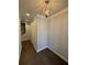 A hallway with hardwood floors and a modern chandelier at 2021 Towneship Trl, Roswell, GA 30075