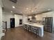 Open-concept kitchen with hardwood floors, marble island, and stainless steel appliances at 2021 Towneship Trl, Roswell, GA 30075