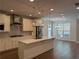 Bright kitchen with marble island, stainless steel appliances, and stylish pendant lighting at 2021 Towneship Trl, Roswell, GA 30075