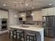 Modern kitchen features a large island with seating, stainless steel appliances, and white cabinetry at 2021 Towneship Trl, Roswell, GA 30075