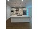 Bright kitchen featuring white cabinets, stainless steel appliances, and a large island with countertop seating at 2021 Towneship Trl, Roswell, GA 30075