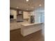 Bright kitchen featuring white cabinets, stainless steel appliances, and a large island with countertop seating at 2021 Towneship Trl, Roswell, GA 30075