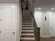 Elegant staircase with wood railing and white trim, leading to the upper level at 2021 Towneship Trl, Roswell, GA 30075