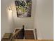 View looking down staircase with wood railing and a painting hanging on the wall at 2021 Towneship Trl, Roswell, GA 30075