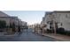 Charming street view of townhomes behind a black gated entrance and well-maintained landscaping at 2021 Towneship Trl, Roswell, GA 30075