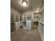 Spacious walk-in closet features custom shelving and ample storage for clothes and accessories at 2021 Towneship Trl, Roswell, GA 30075
