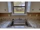 A kitchen sink with granite countertops and white cabinets at 3003 Landmark Dr, Conyers, GA 30094