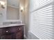 Bathroom vanity featuring granite countertop and traditional lighting fixtures at 572 Vinings Estates Se Dr # B9, Mableton, GA 30126