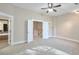 Bedroom with neutral carpet, ceiling fan and access to bathroom and hallway at 572 Vinings Estates Se Dr # B9, Mableton, GA 30126